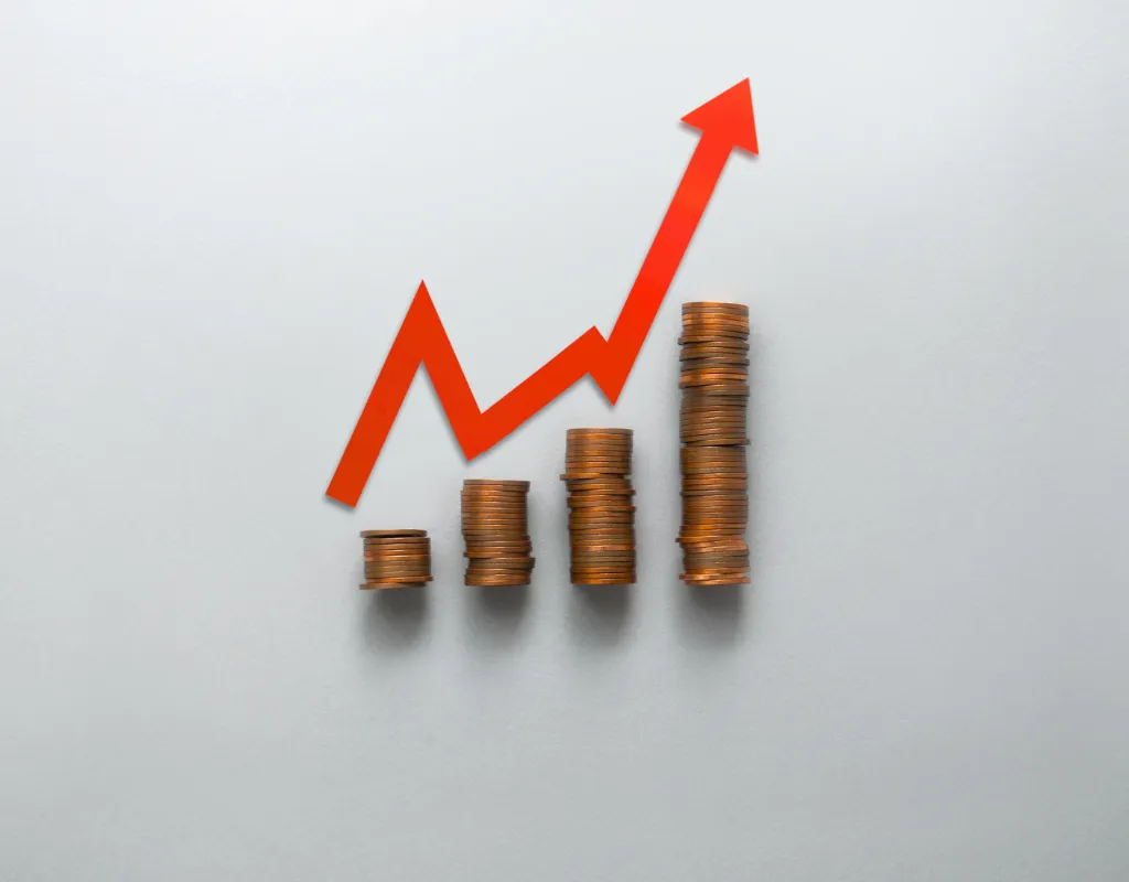 stacks of coins with an arrow pointing up