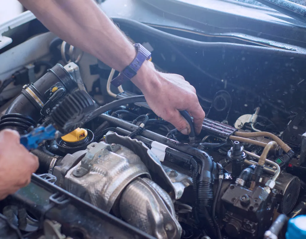 a person working on a car engine