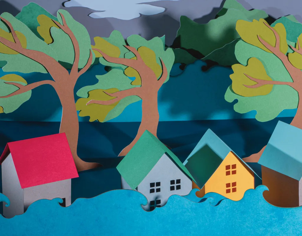 a paper cut out of houses and trees