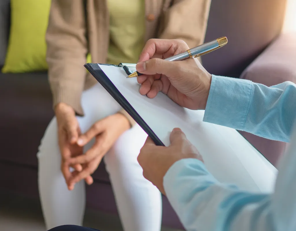 a person holding a pen and clipboard