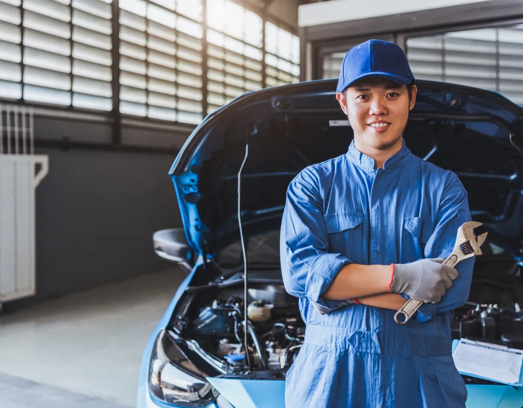 a man in a blue uniform holding a wrench