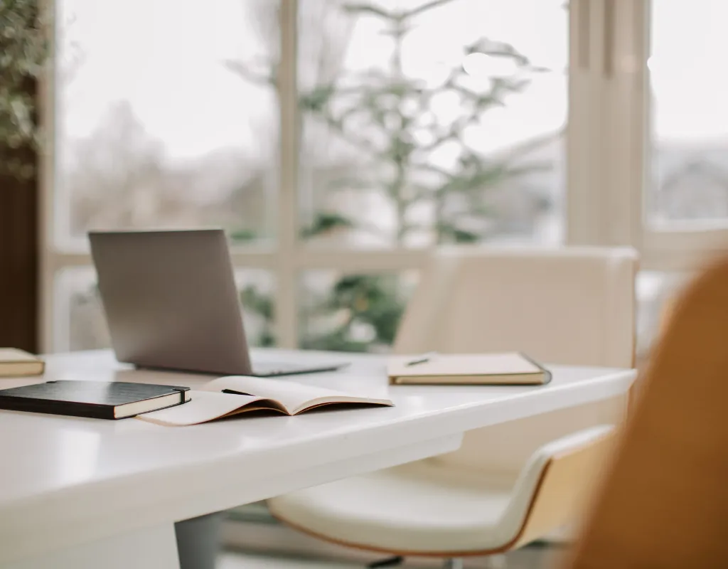 a laptop and notebook on a table
